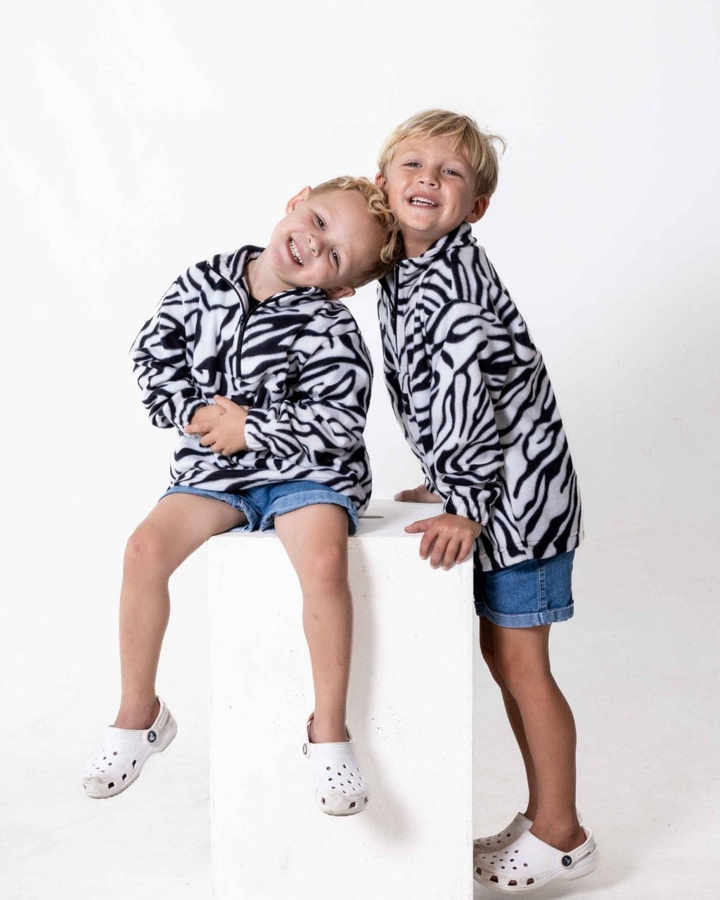 Children wearing the Kids Safari animal print jersey in zebra print