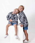 Children wearing the Kids Safari animal print jersey in zebra print