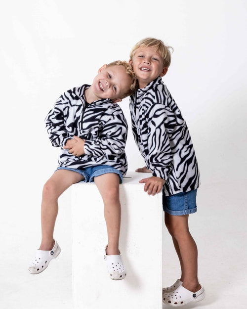 Children wearing the Kids Safari animal print jersey in zebra print