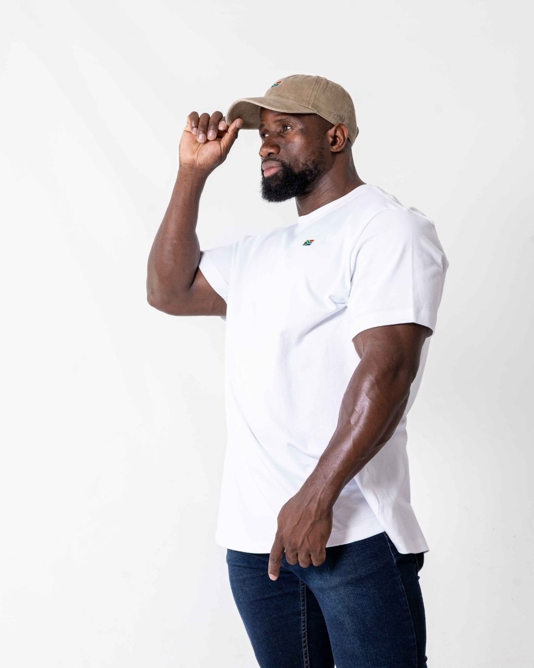 Male wearing a white Oversized SA T- Shirt with a white background. 