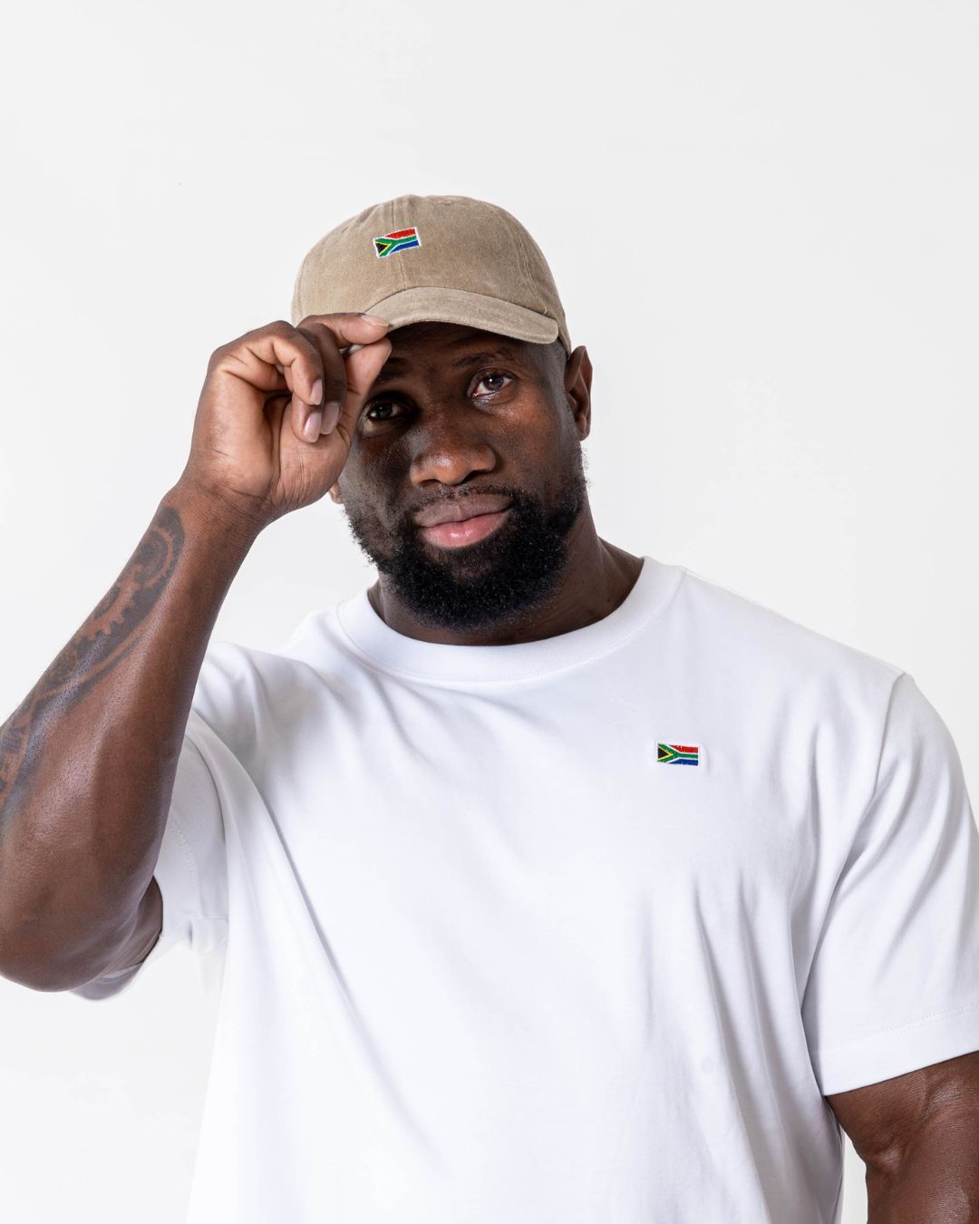 Male wearing the SA flag cap in colour beige - front view