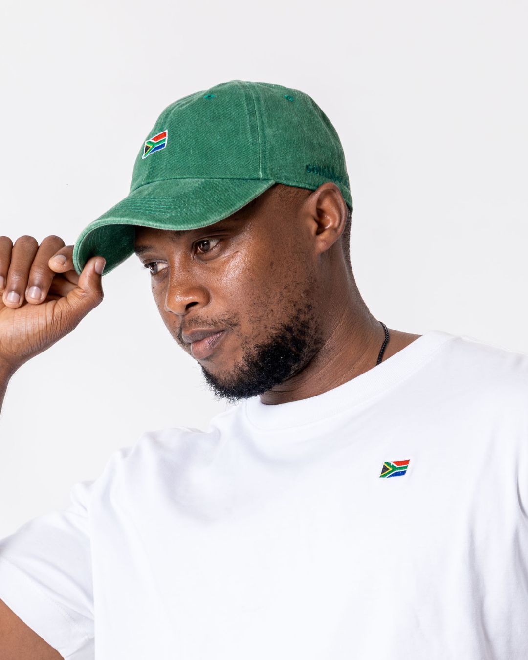 Male wearing the green SA Flag cap - side view 

