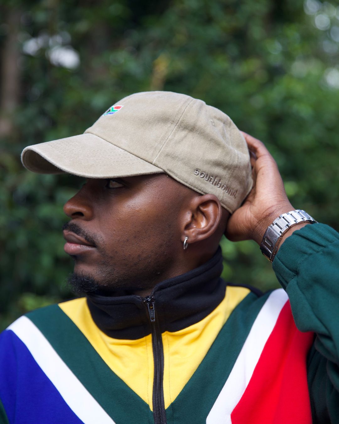 Male wearing a beige SA flag cap - Side view - outside