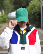 Female wearing a green SA flag cap outdoors