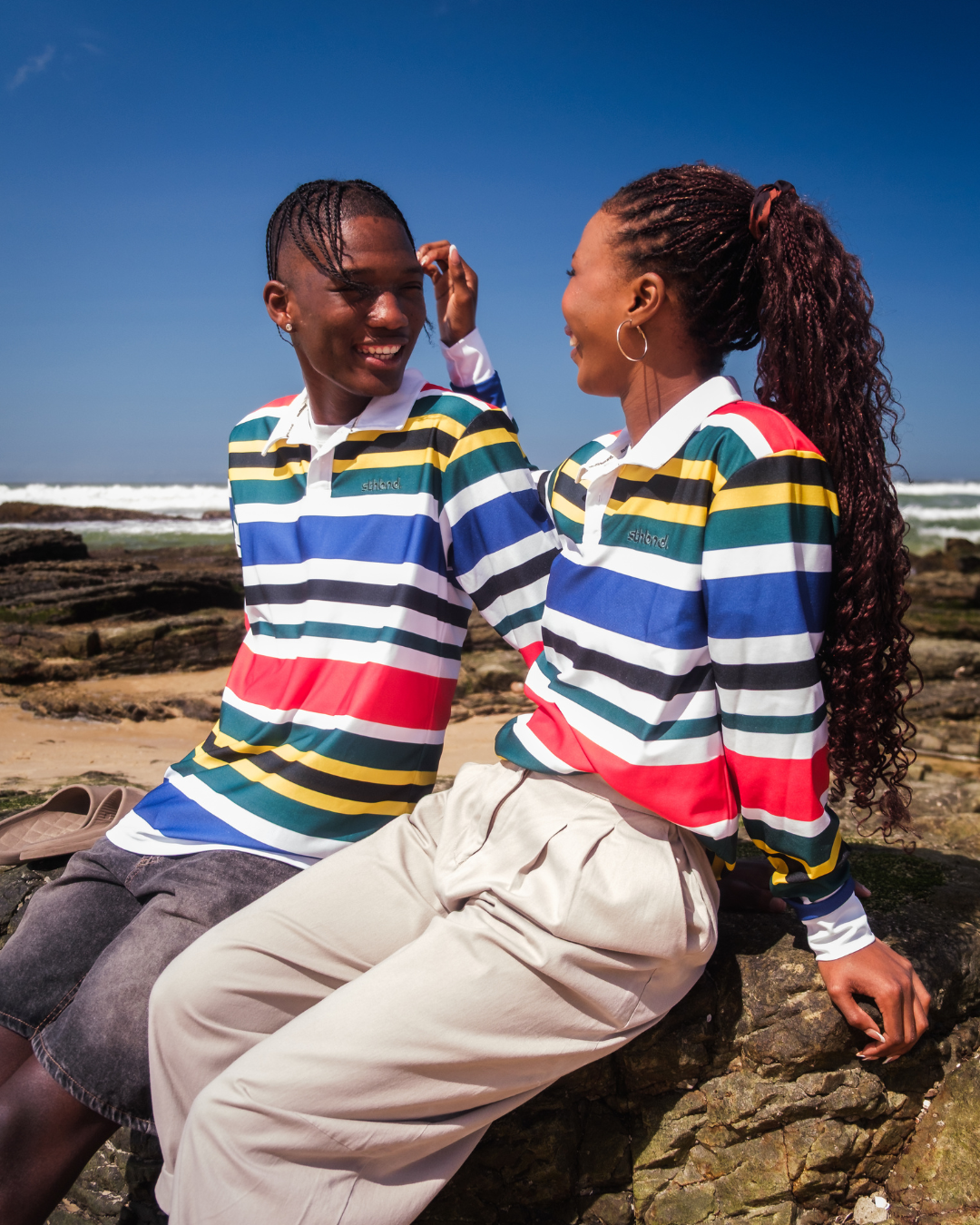 Male and female wearing a stripe polo shirt on the beach