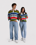 A man and a woman modeling matching long-sleeve striped rugby shirts with light-wash jeans and white sneakers against a plain light gray studio background.