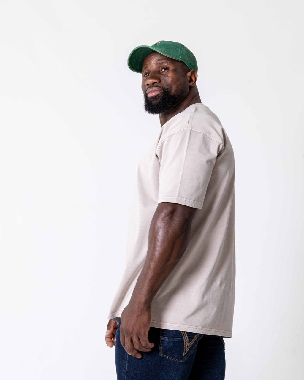 Side view of a male wearing the southbound staple oversized  T- Shirt