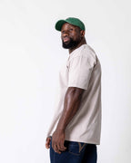 Side view of a male wearing the southbound staple oversized  T- Shirt