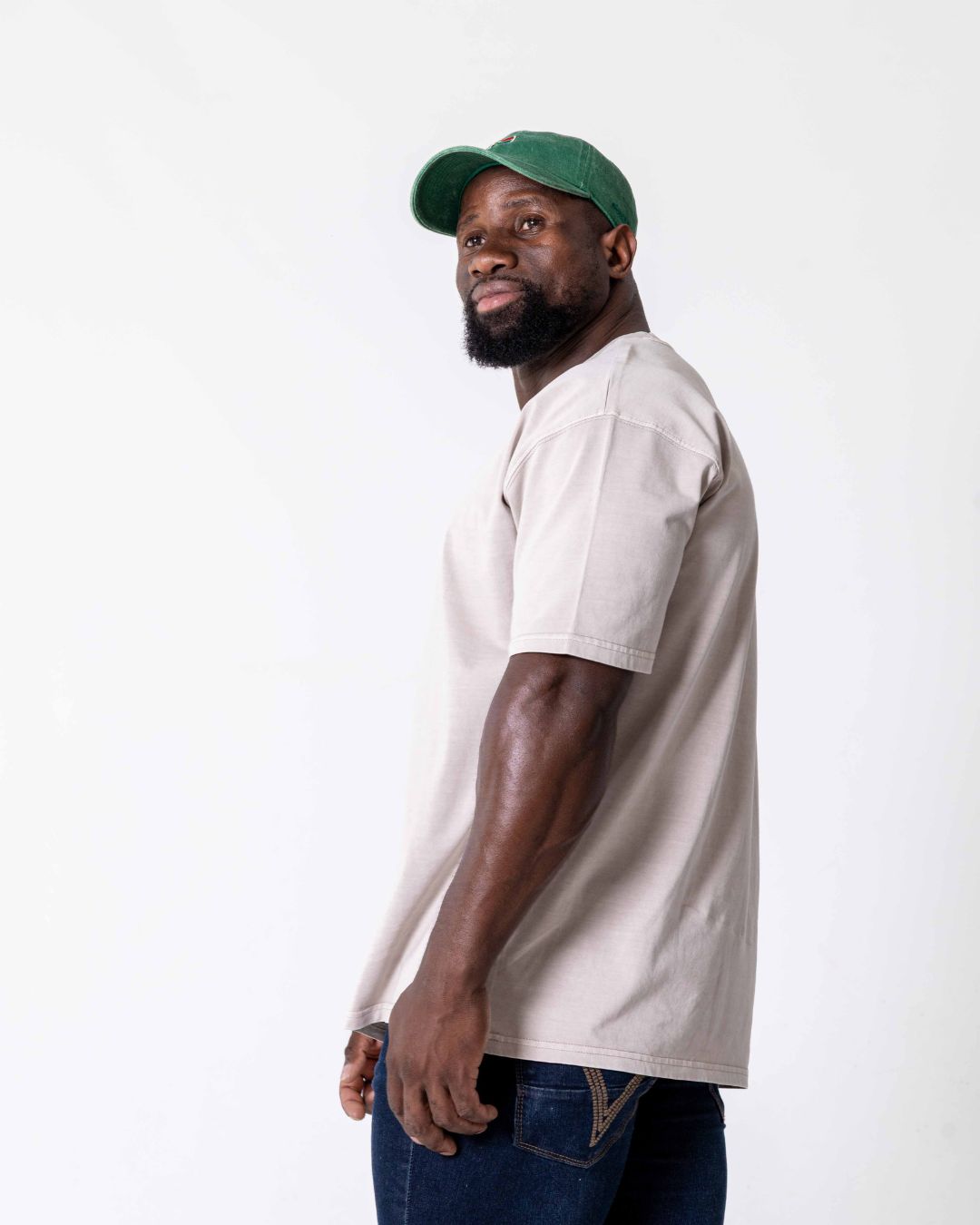 Side view of a male wearing the southbound staple oversized  T- Shirt