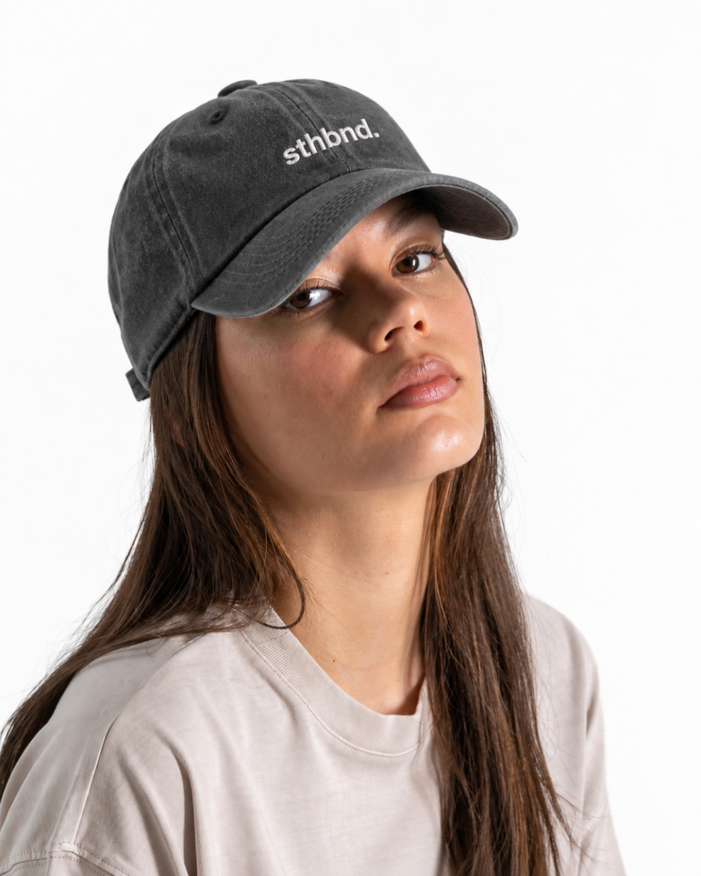 Female wearing a charcoal/ khaki cap wth the sthbnd logo on the front